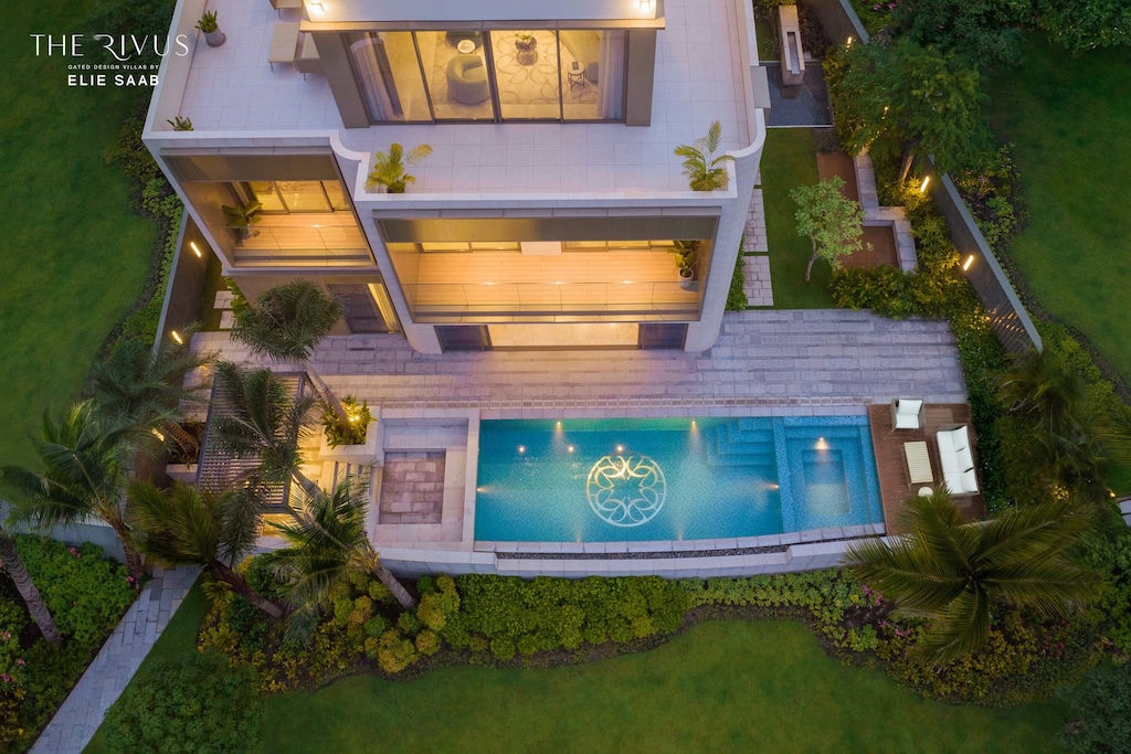 Mặt sau dinh thự nhìn từ trên cao với hồ bơi có logo Elie Saab. Không gian sau dinh thự gồm khu vực Jacuzzi và BBQ.